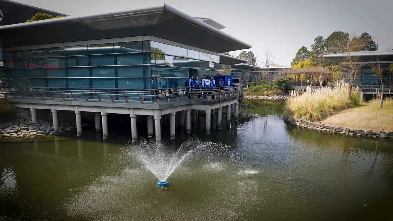 building beside a pond with fountain at the China paddock