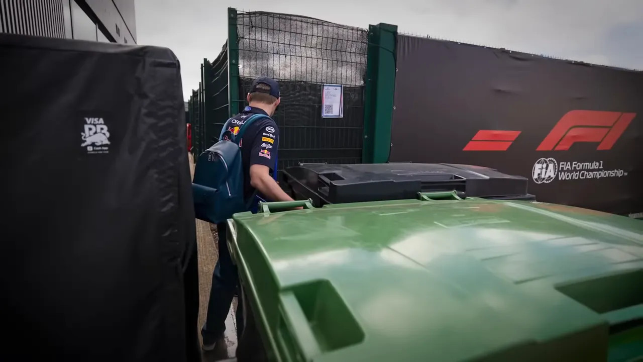 driver walking behind large green garbage bins beside black paddock wall