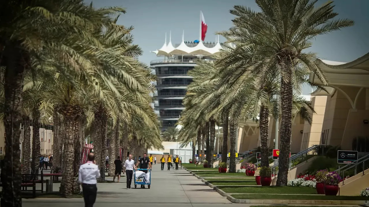 palm lined walkway in Bahrain paddock with tower in the distance