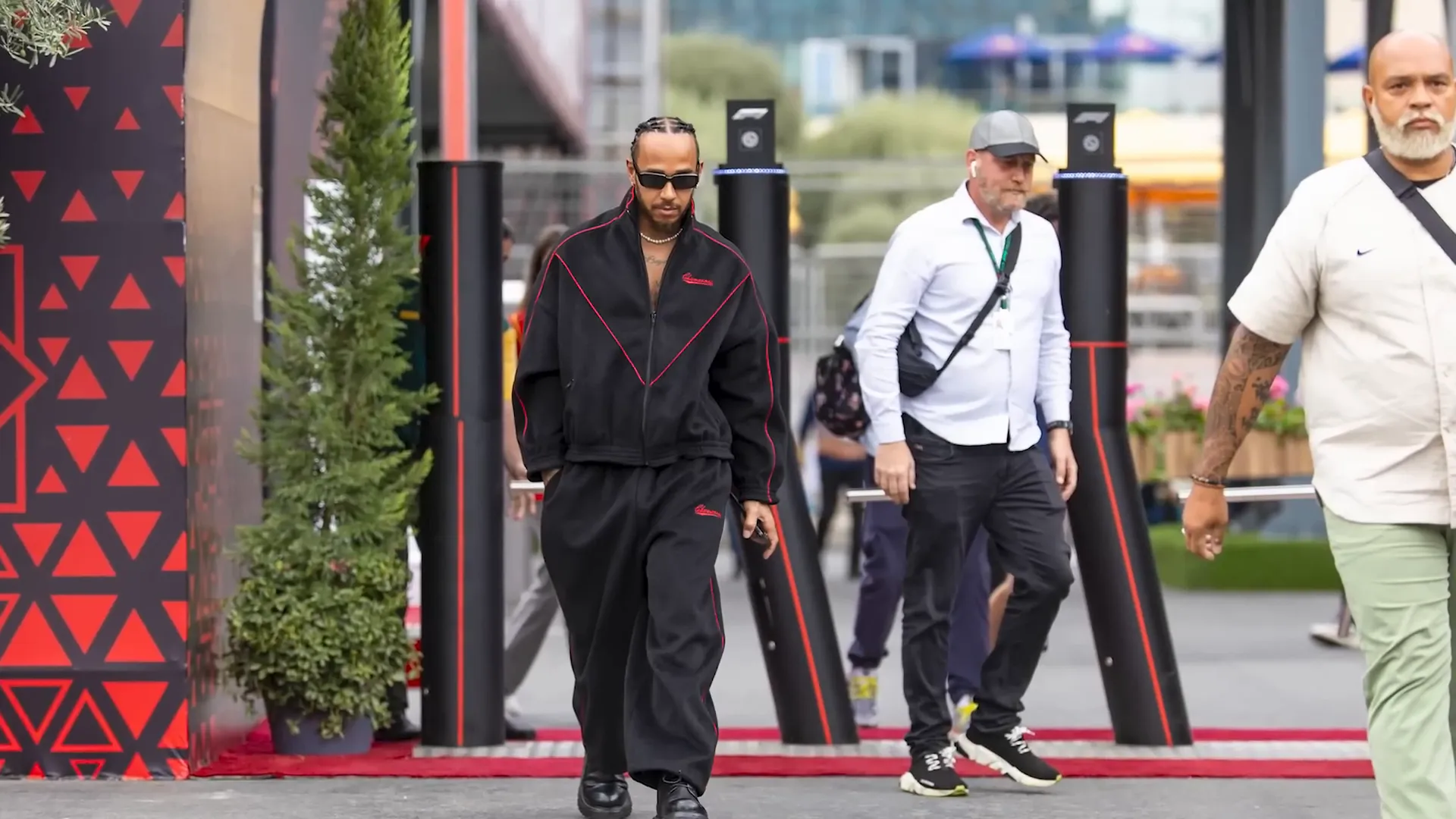 Lewis Hamilton with his security team