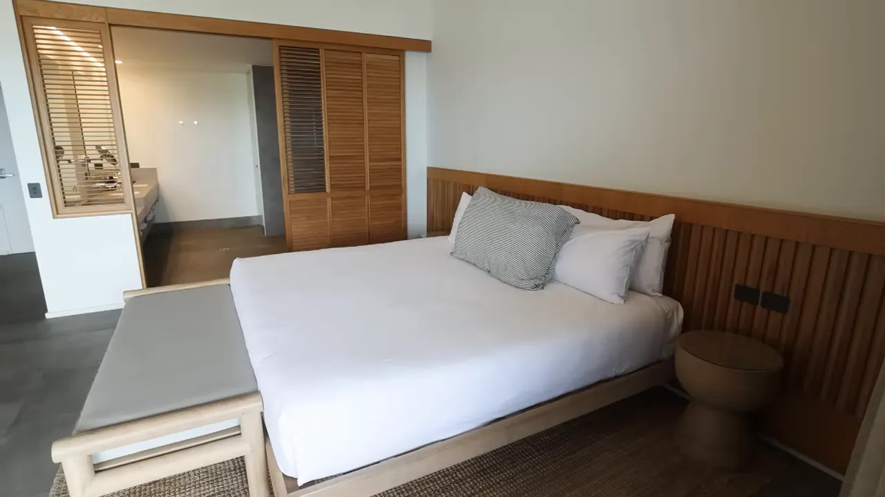 Modern bedroom inside an upscale Rottnest Island lodge with a large bed