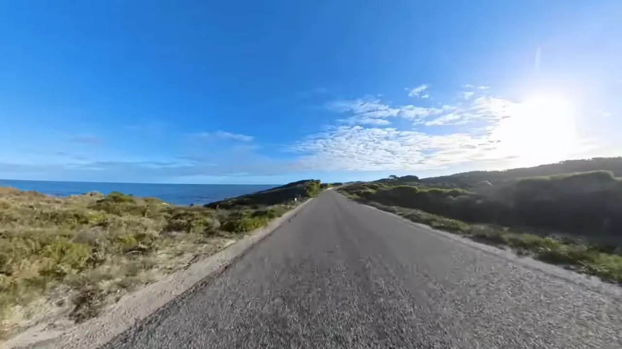 Road cycling route on Rottnest Island with ocean and coastal scenery