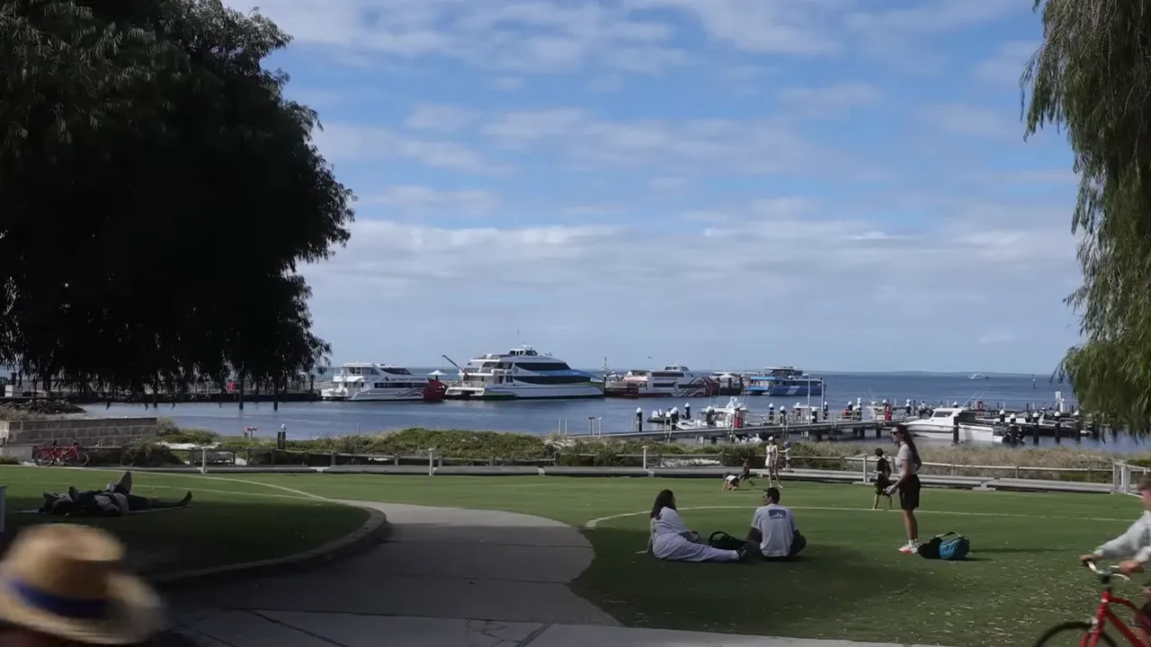 Rottnest Island waterfront with yachts and marina view through trees and walkway