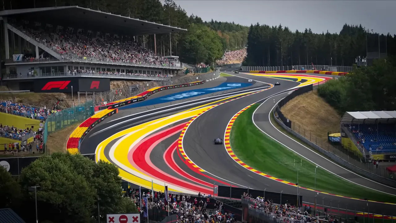 Formula 1 cars climbing through Eau Rouge at Spa-Francorchamps
