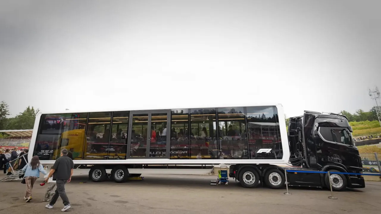 Long glass-sided dining vehicle parked near Spa circuit