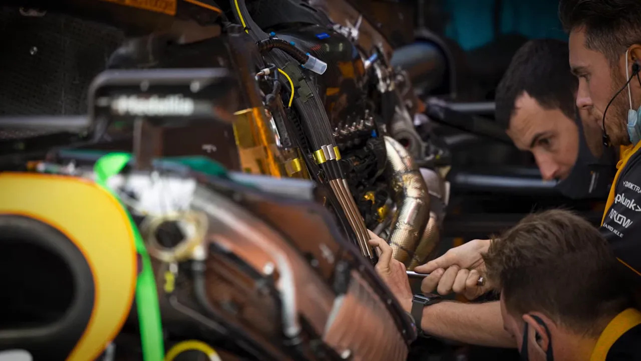 Formula 1 garage crew working on car components