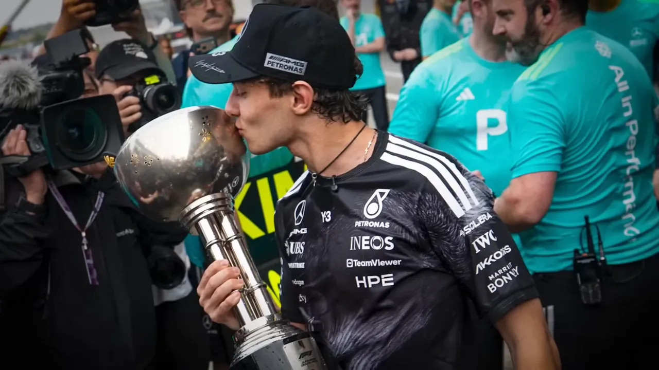Max Verstappen celebrating with a trophy in Mercedes-themed celebrations