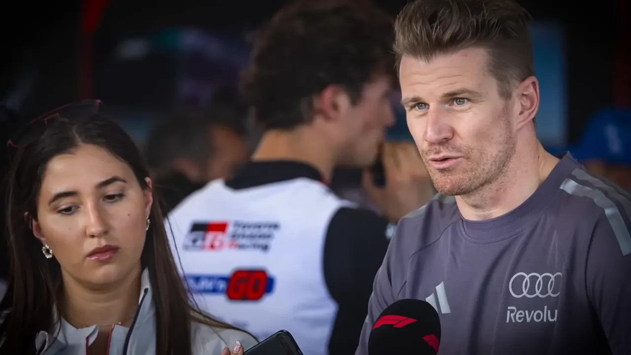 F1 communications staff member near the Red Bull driver during media remarks