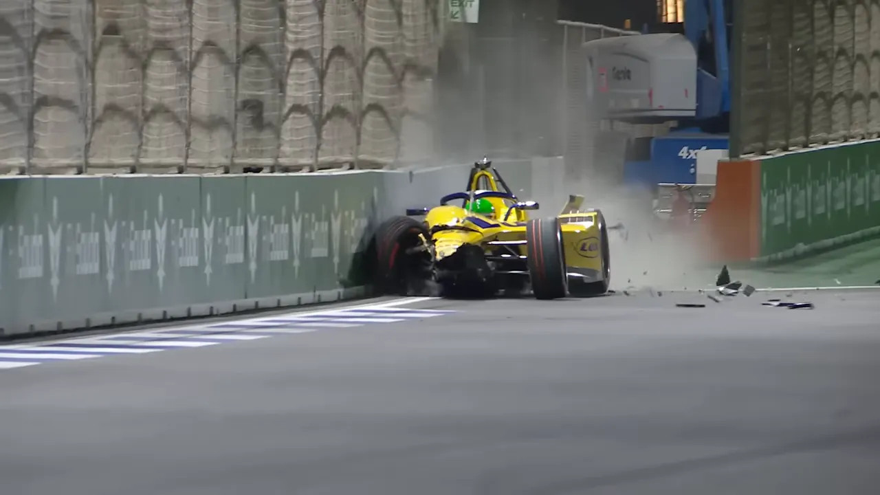 Close frontal shot of a Formula E car colliding with a concrete barrier with debris flying
