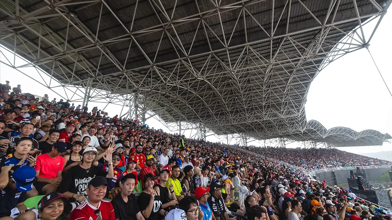 Packed grandstands beneath Sepang's large roof structure