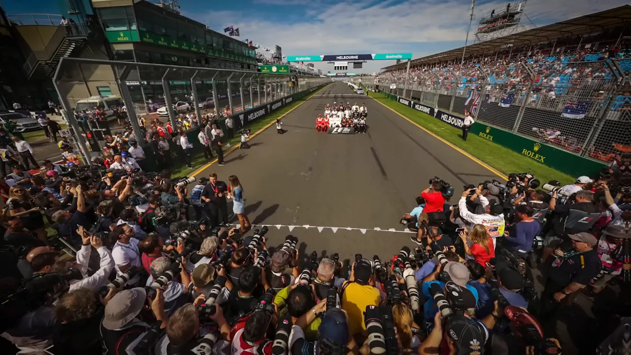 Wide shot of photographers lining the circuit at Melbourne Grand Prix during F1