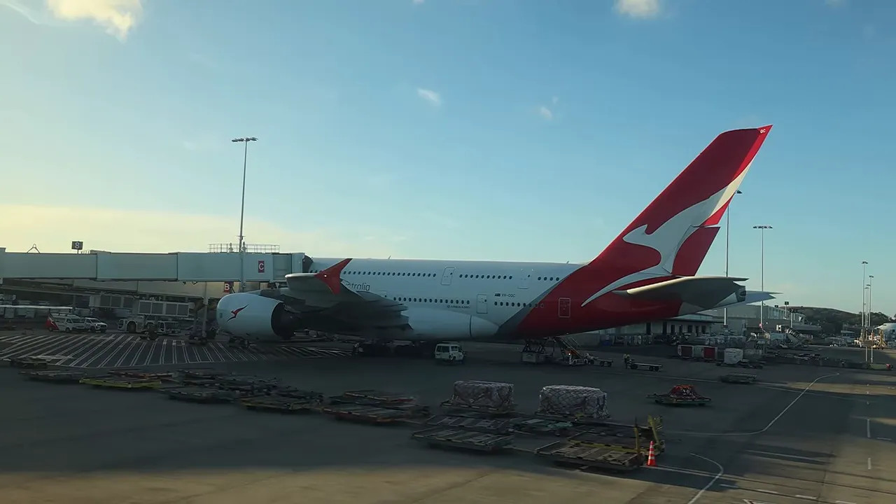 Qantas Airbus A380 parked beside a terminal jet bridge