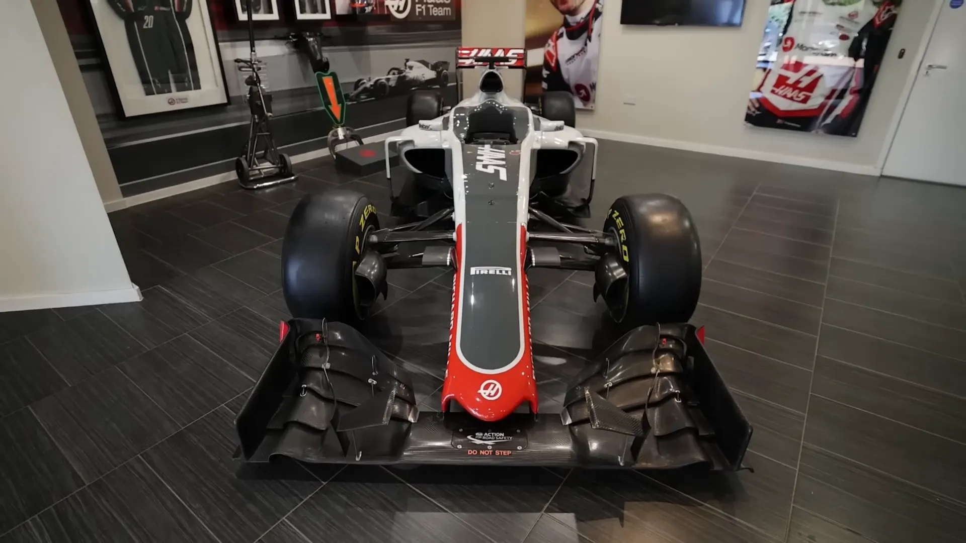 Haas F1 team reception area with cars and driver equipment