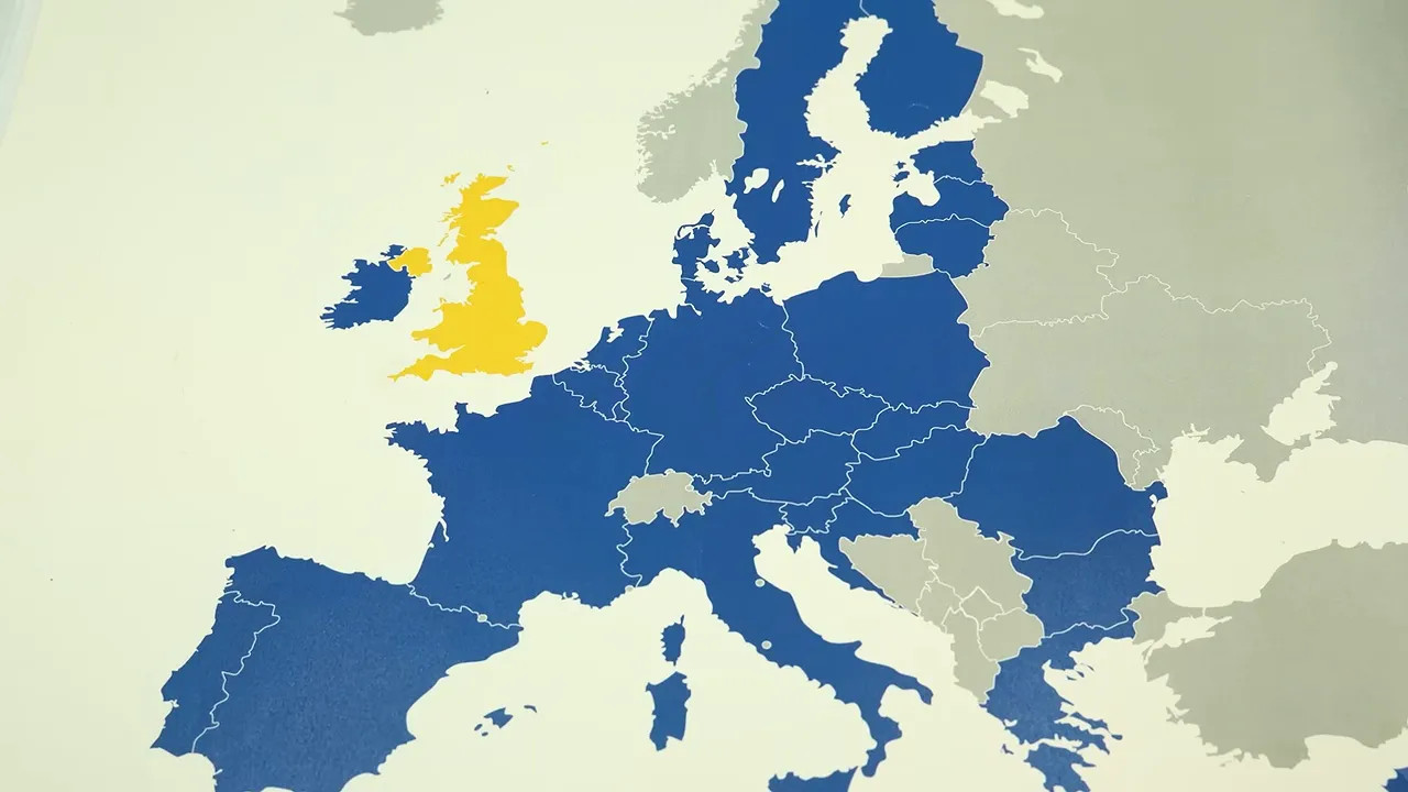 Passport and phone displaying travel to Europe entry exit system over map of Europe