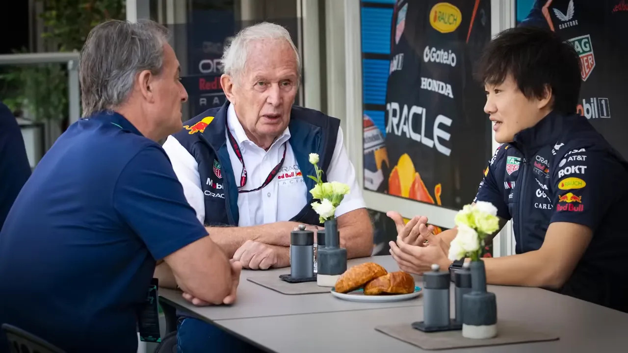 Helmut Marko speaking with team members