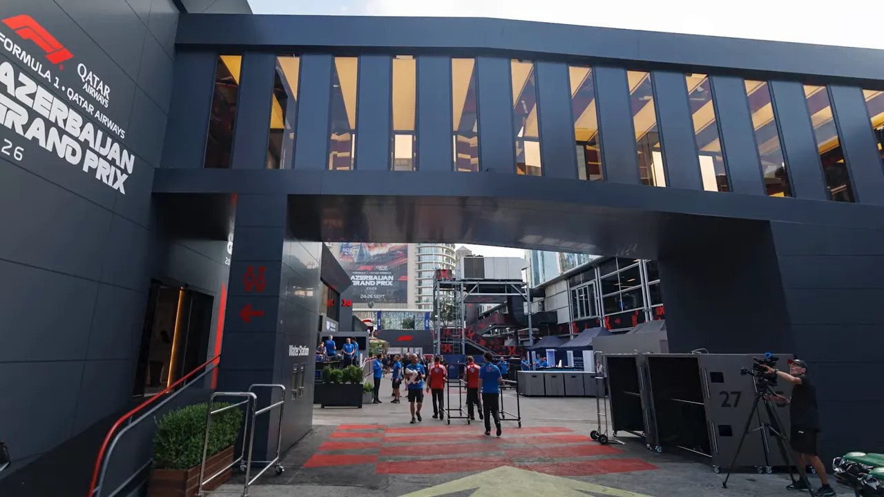 Bridge spanning the paddock walkway between dark hospitality buildings