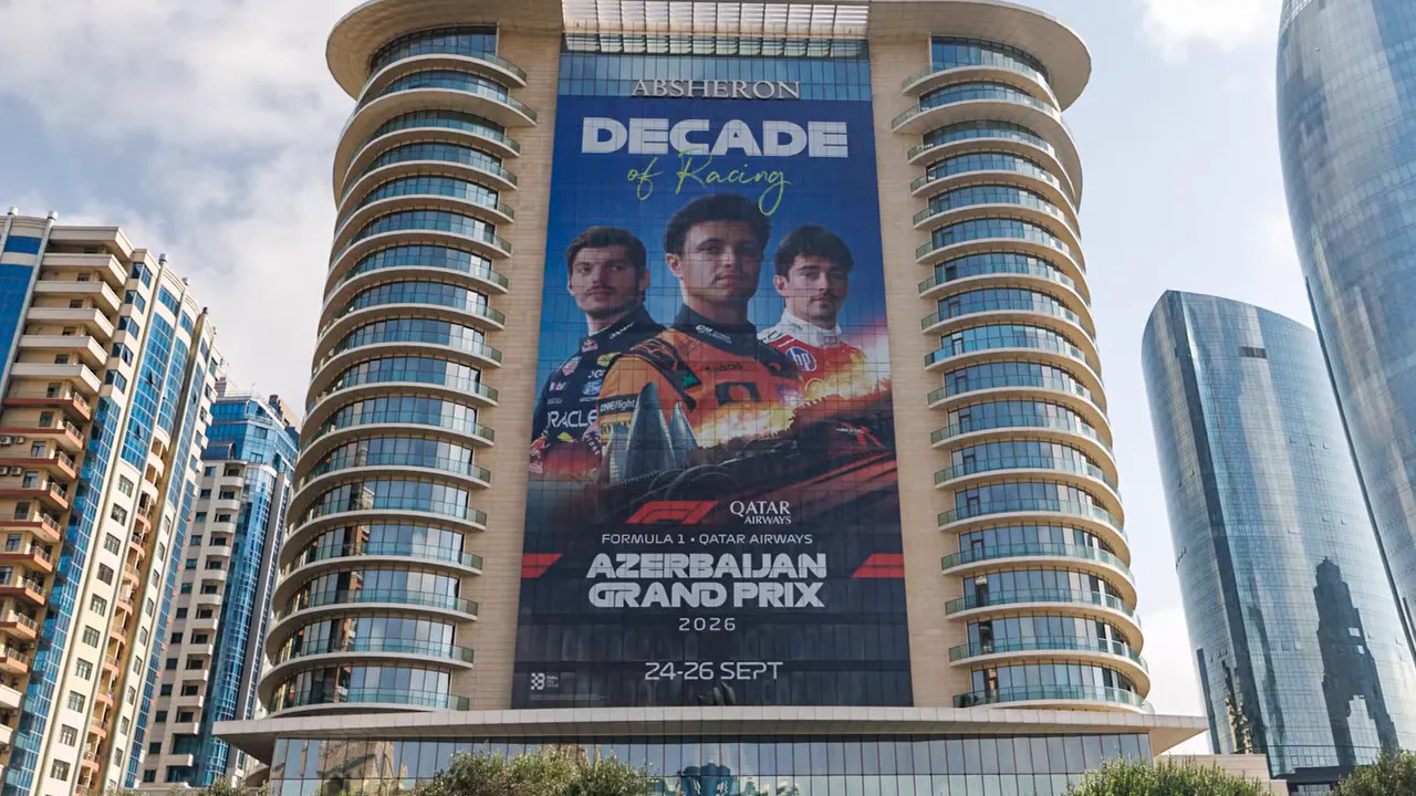 Large Azerbaijan Grand Prix banner featuring three drivers across a tall hotel facade