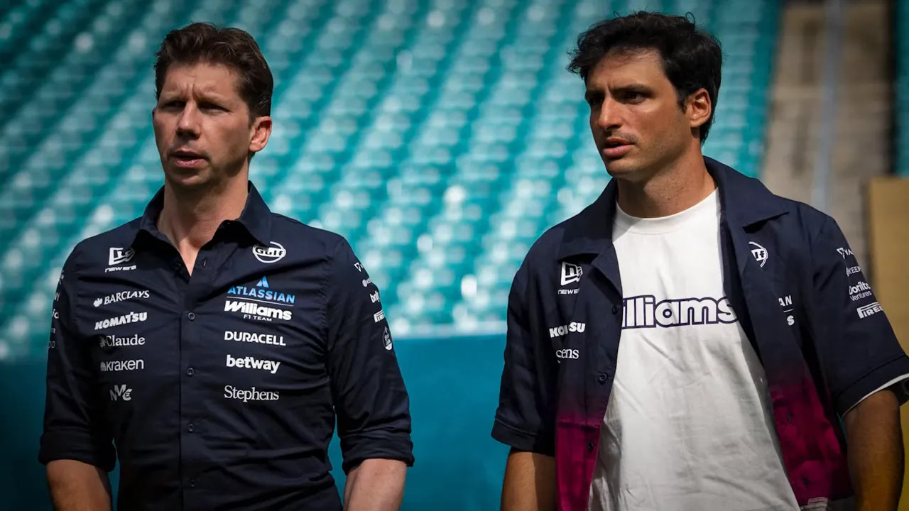 James Vowles and Carlos Sainz wearing Williams team clothing beside empty grandstand seats
