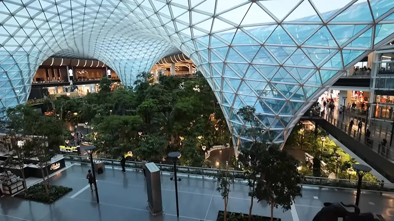 Indoor garden beneath the curved glass roof at Hamad International Airport