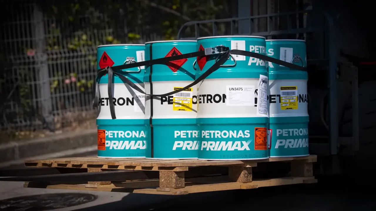 F1 fuel drums on a pallet with Petronas branding and hazardous shipping labels