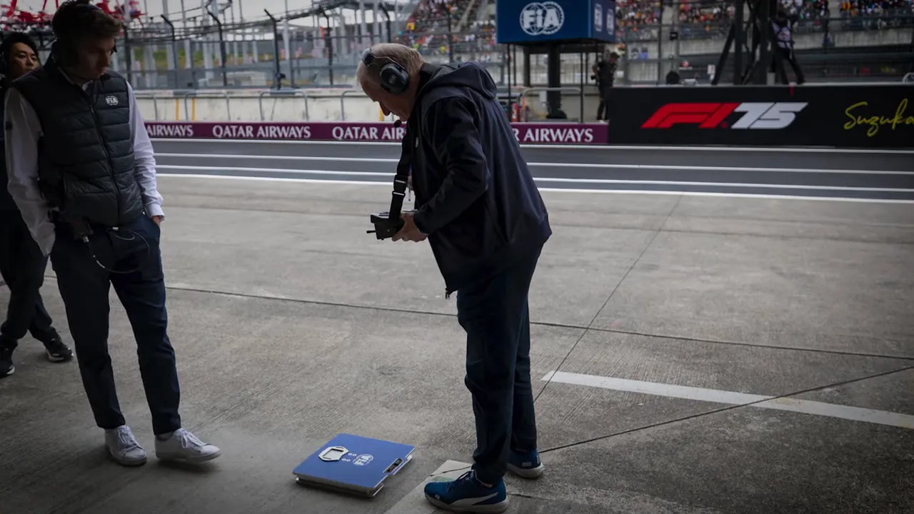 Official driver weigh-in process with scales and officials