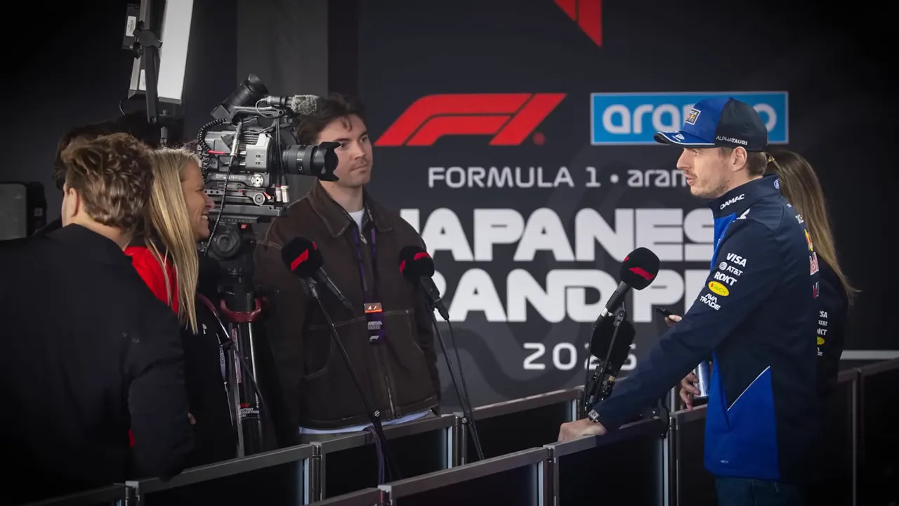 Max Verstappen being interviewed on stage with microphones and media cameras at the Japanese Grand Prix
