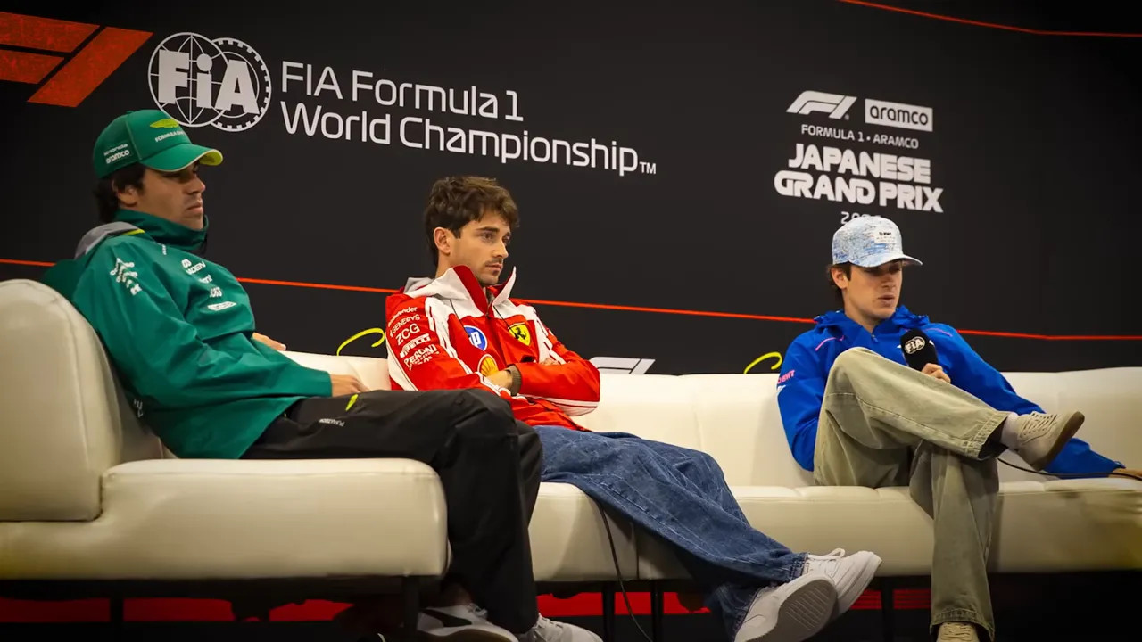 Max Verstappen seated in a hospitality suite with other attendees at the Japanese Grand Prix