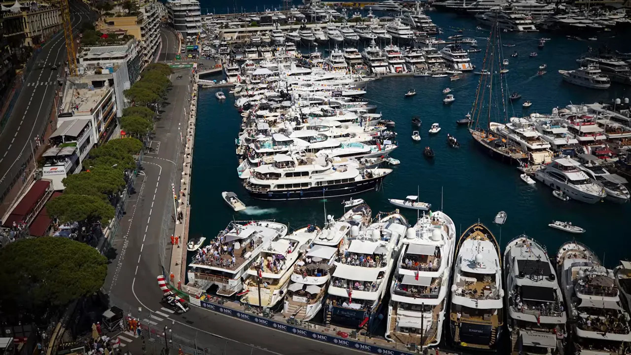 Overhead view of Monaco harbour with yachts and the track curving tightly along the waterfront
