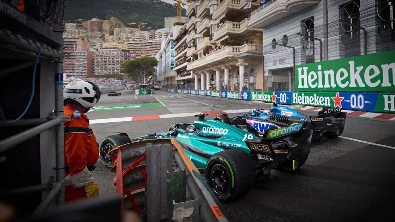 Two Formula 1 cars side by side approaching the chicane near Heineken signage