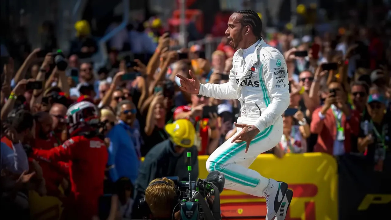 Lewis Hamilton in a Mercedes after the race celebrating with the crowd behind him