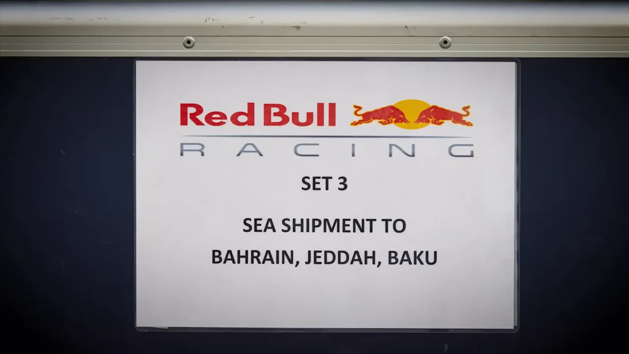 Centered sign: 'Red Bull Racing SET 3 SEA SHIPMENT TO BAHRAIN, JEDDAH, BAKU' displayed on a container