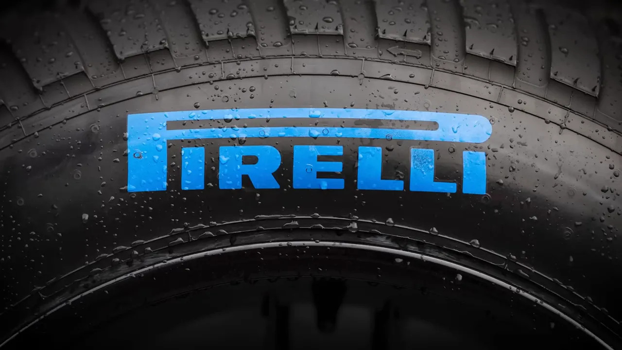 Close-up of a Pirelli tyre with blue Pirelli logo and water droplets on the tread