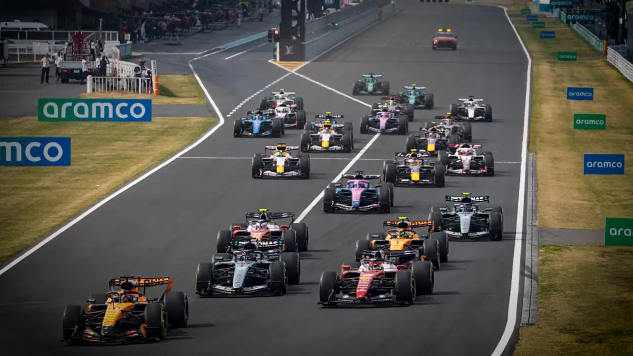 Formula 1 cars racing in a close group during a Miami-style start on track