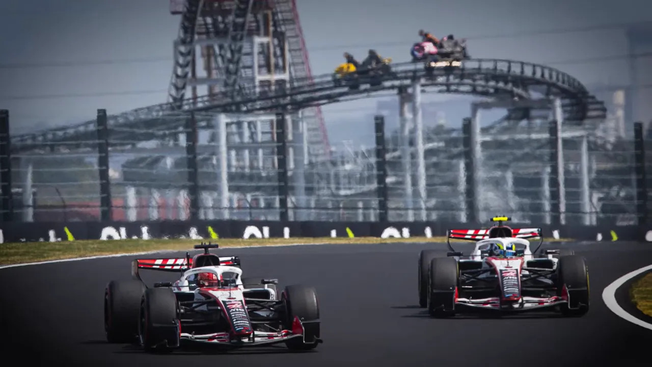 Front-on view of two Formula 1 cars racing at Miami with a stadium backdrop and other cars following