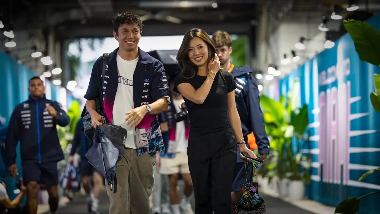 Two guests walking through the Miami Grand Prix paddock corridor