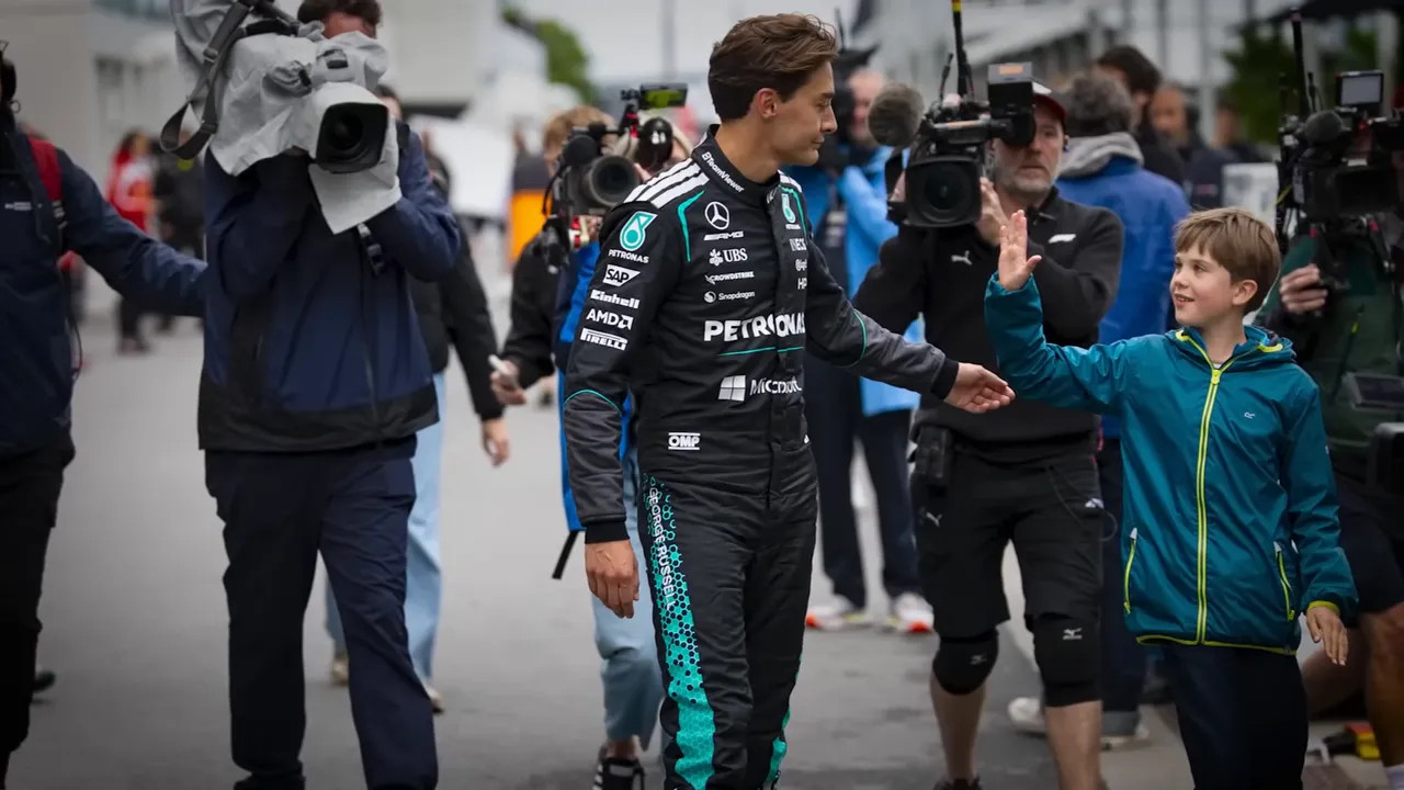 George Russell greeting a young fan in the paddock during the Canadian GP weekend