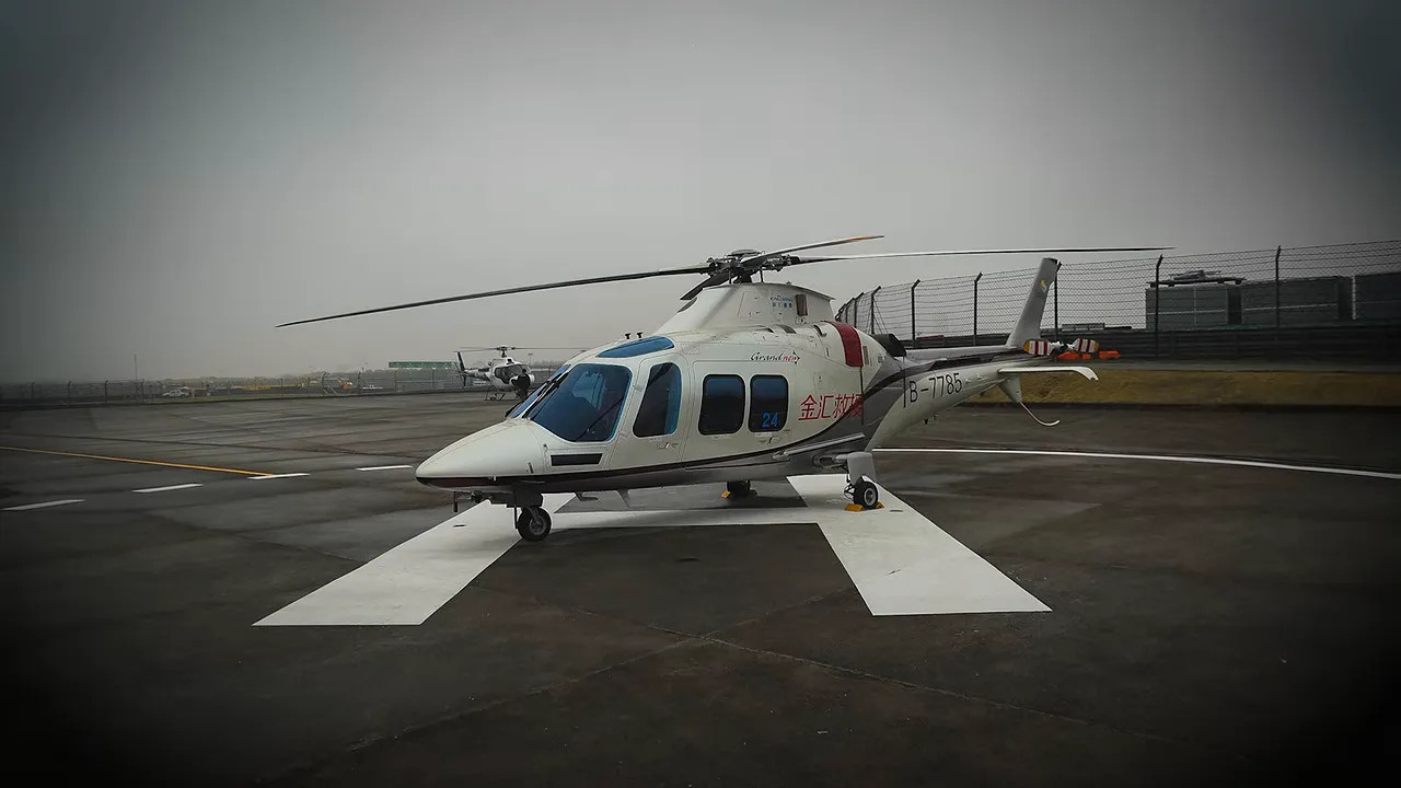 Medical helicopter parked on a helipad in hazy conditions