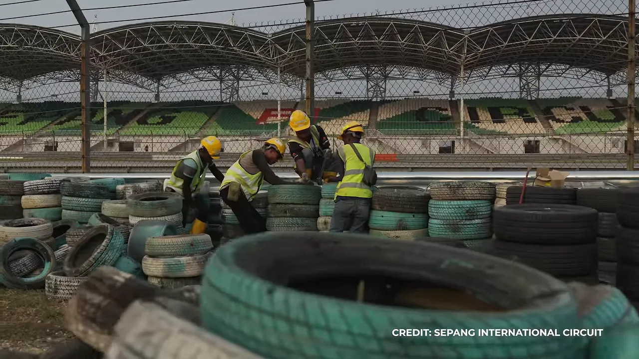 Workers repairing tire barriers at Sepang International Circuit