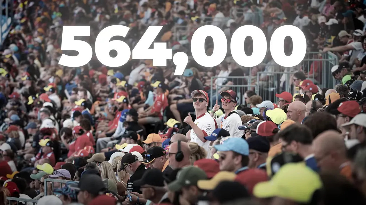Packed grandstand crowd with large white text reading 564000