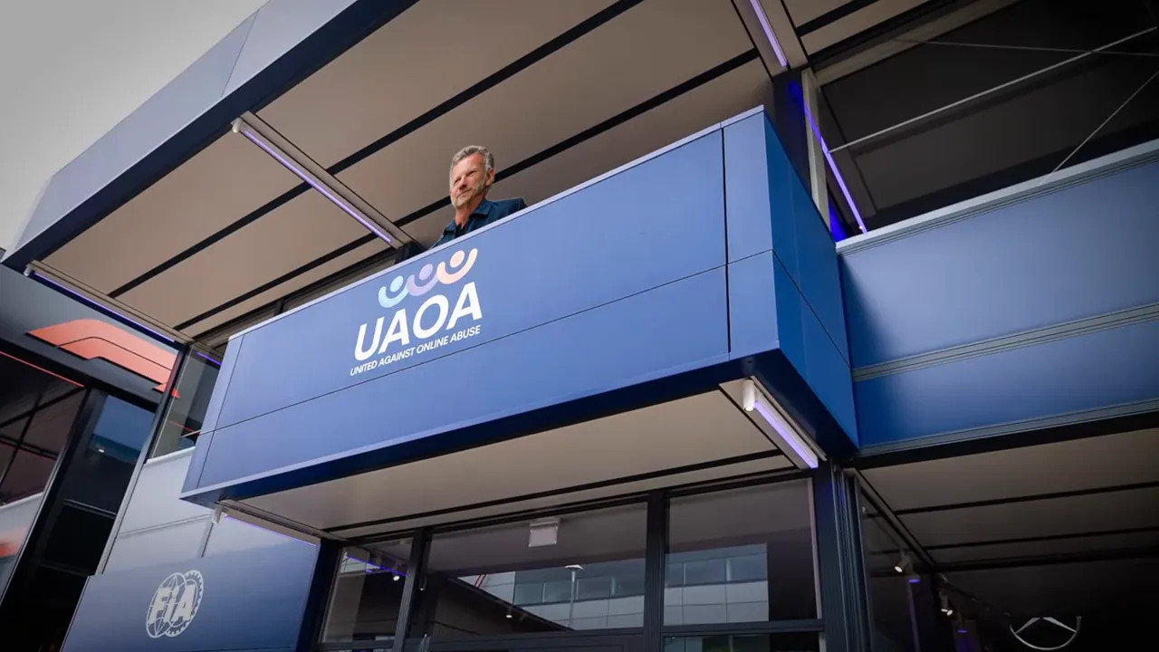 Upper balcony of FIA hospitality building with a person standing above the signage