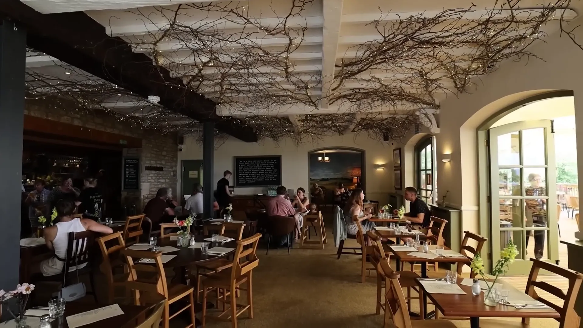 Inside Jeremy Clarkson's pub restaurant showing rustic decor