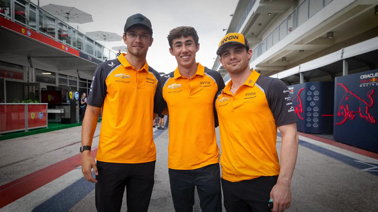 Oscar Piastri chatting with IndyCar drivers in the paddock