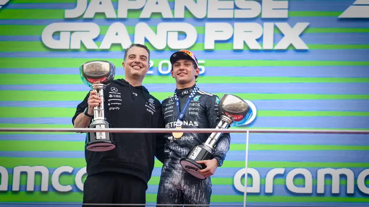 Antonelli and Mercedes team members smiling with trophies at the 2026 Japanese Grand Prix podium