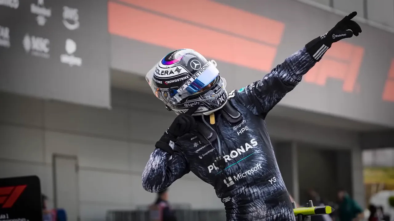 Kimi Antonelli celebrates on track with an arm raised at the Japanese Grand Prix