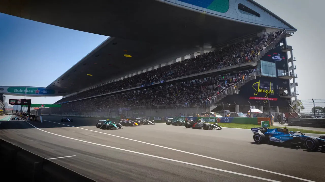 Formula 1 cars racing under Shanghai grandstand during a race